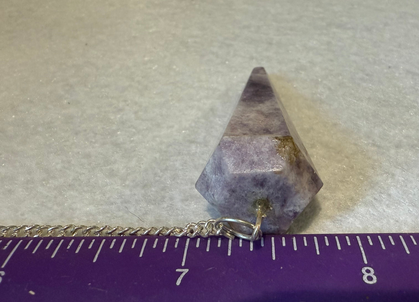 Beautiful Lepidolite Pendulum is  1.65” and with chain is 8.75”.