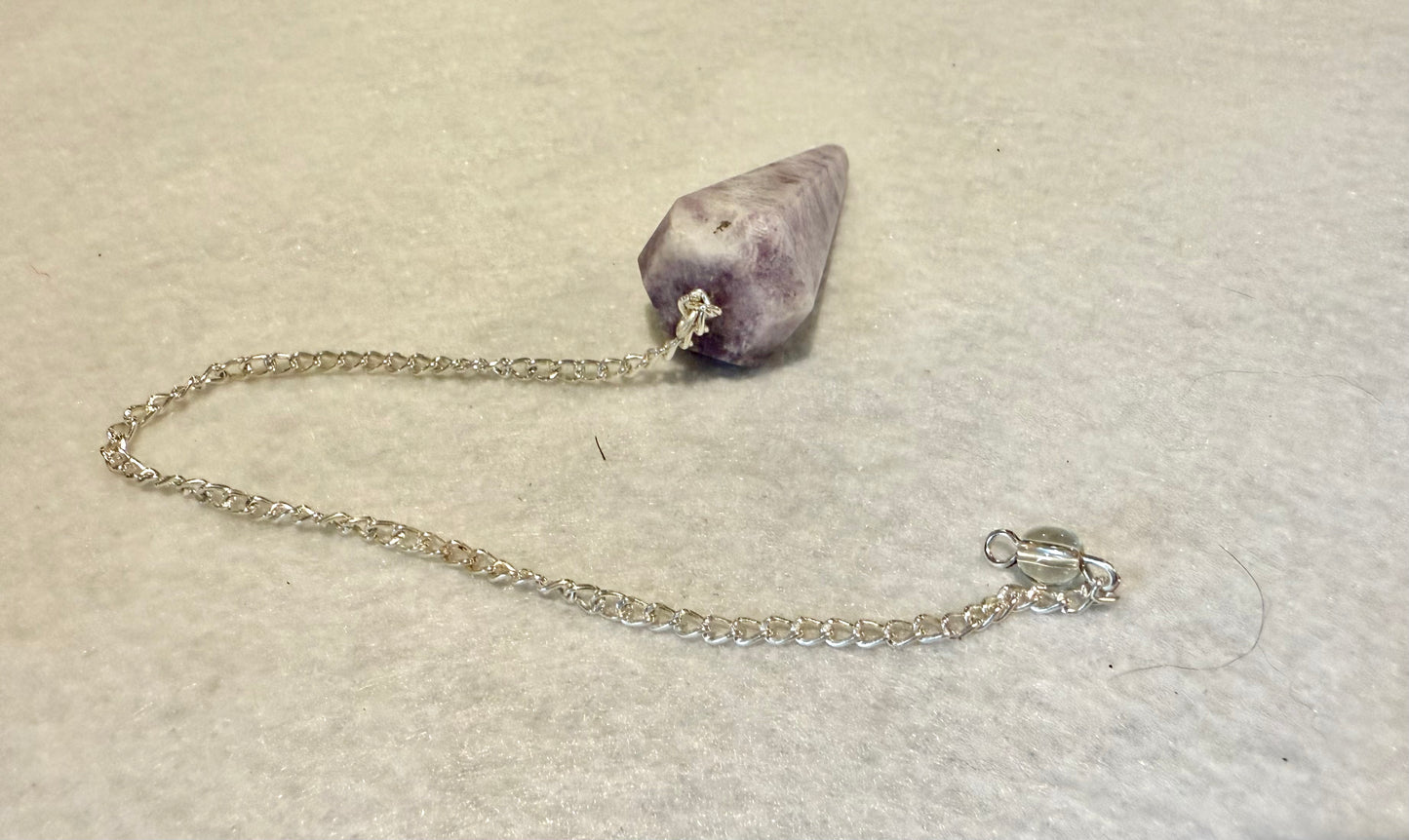 This pretty pink and purple Lepidolite Pendulum is  1.5” and with chain is 9”