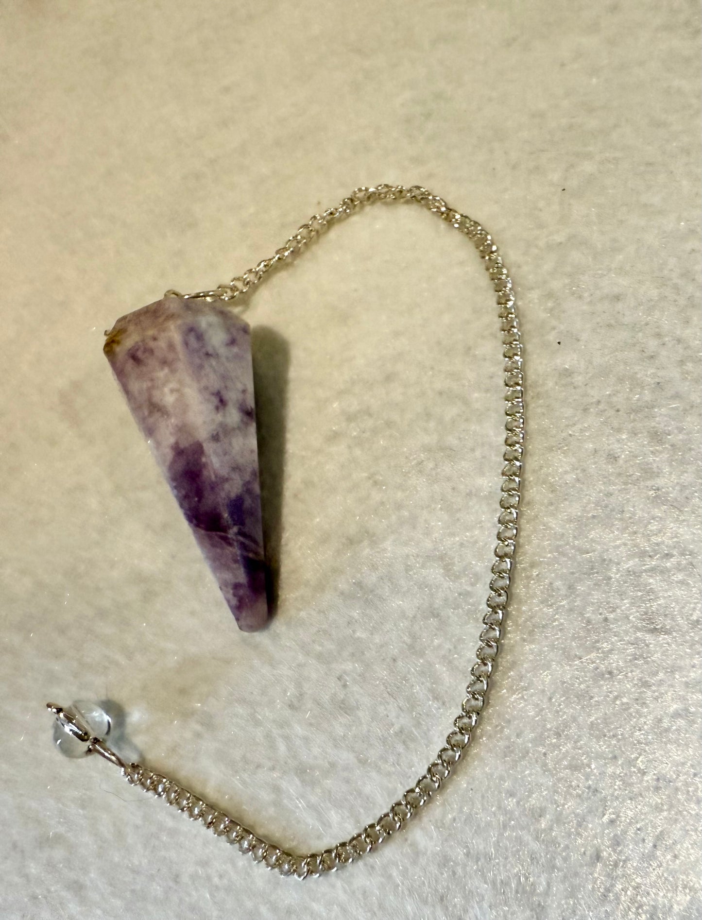 Beautiful Lepidolite Pendulum is  1.65” and with chain is 8.75”.