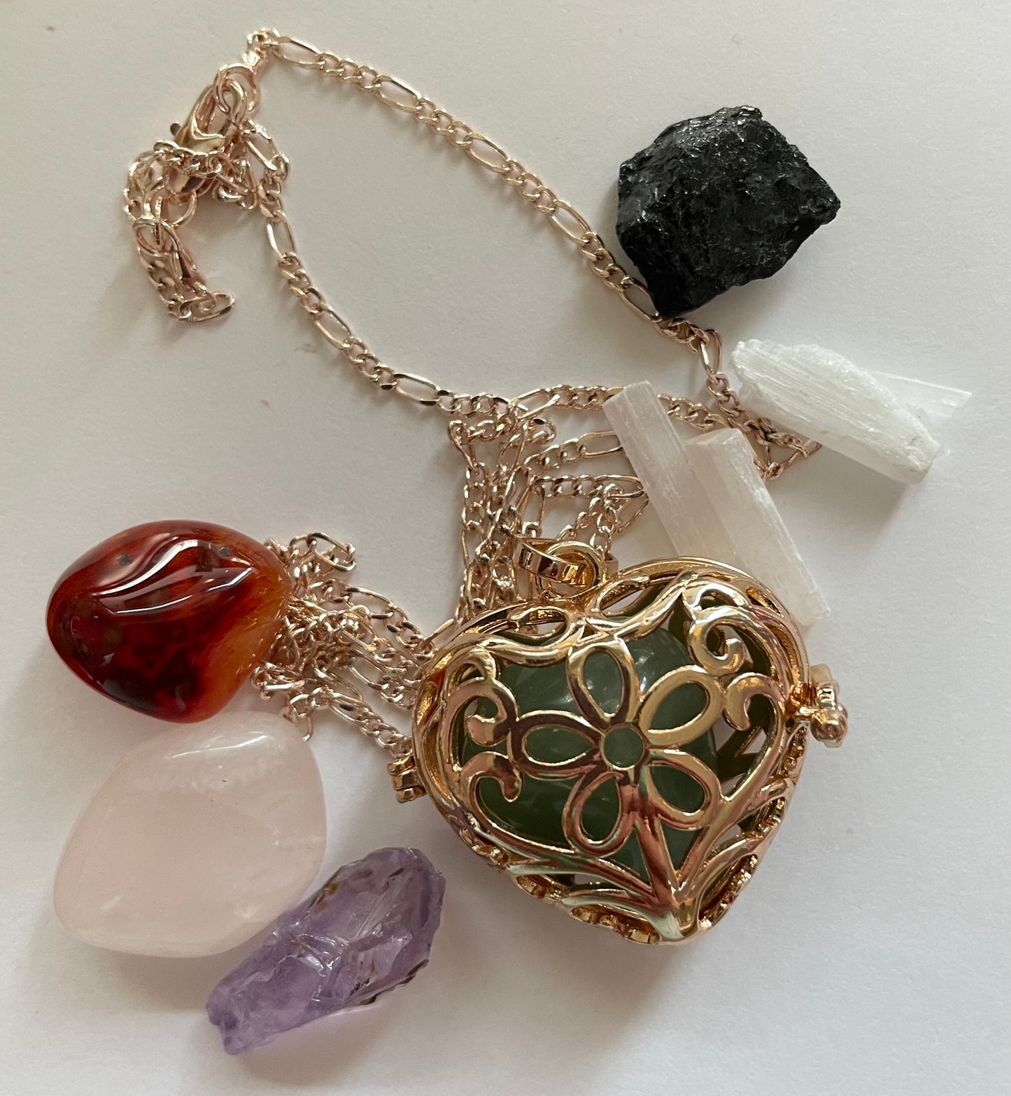 Gold locket filled with 6 interchangeable crystals on 18” rose gold chain