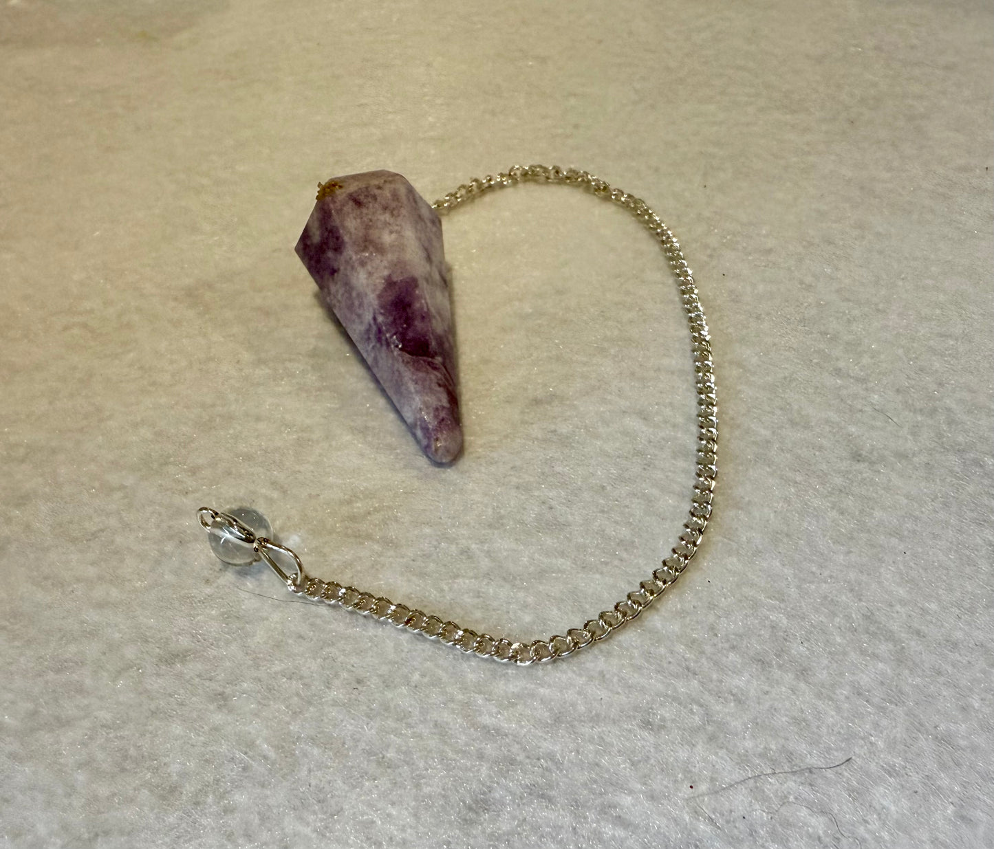 Beautiful Lepidolite Pendulum is  1.65” and with chain is 8.75”.