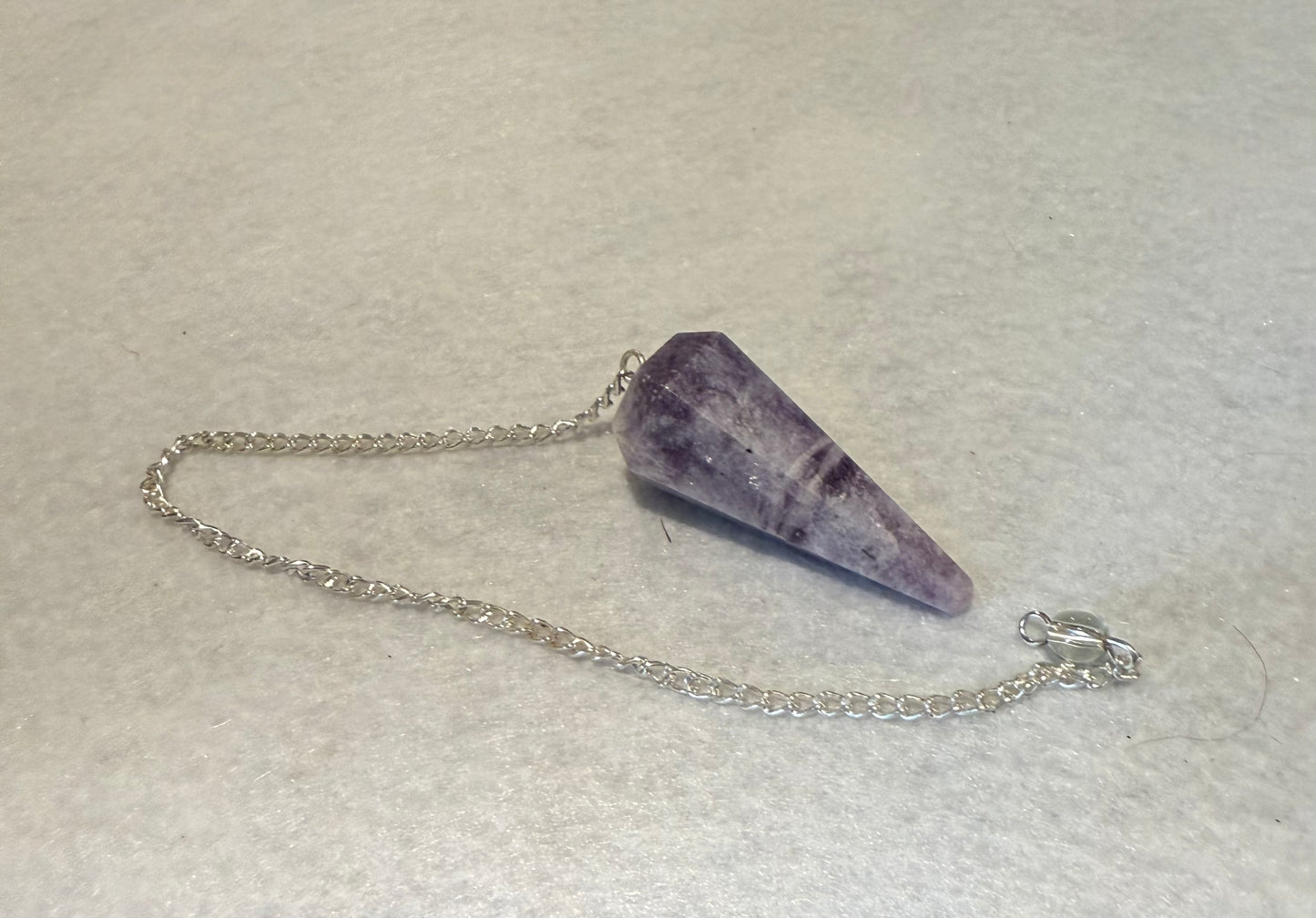This pretty pink and purple Lepidolite Pendulum is  1.5” and with chain is 9”