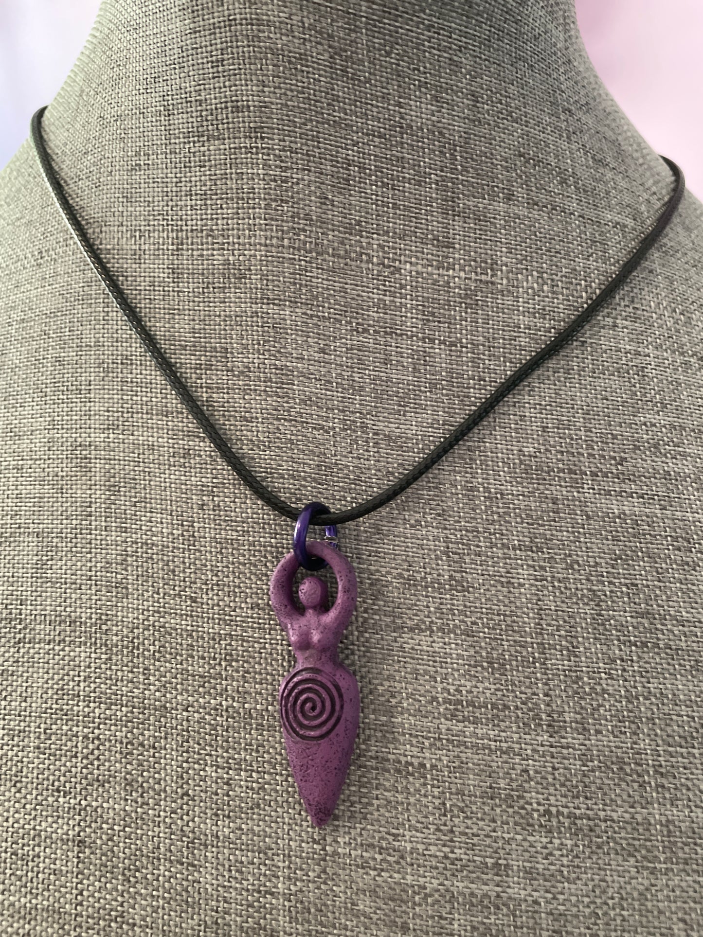 The Goddess pendant necklace on black cord.