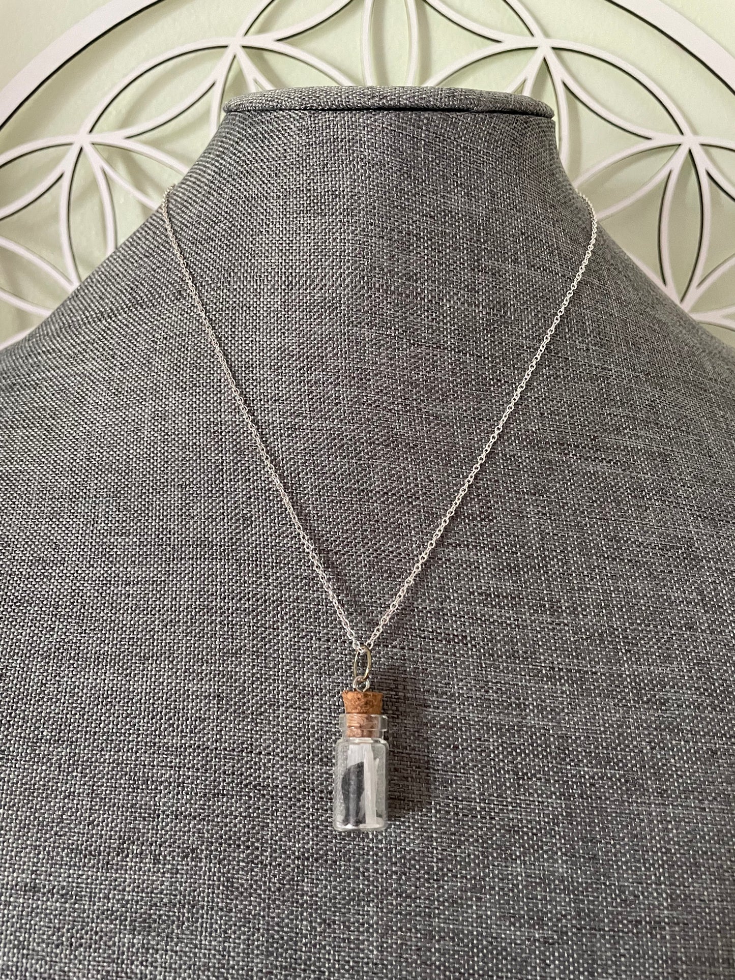 Small bottle earrings and/or necklace filled with a Powerful crystal protection.