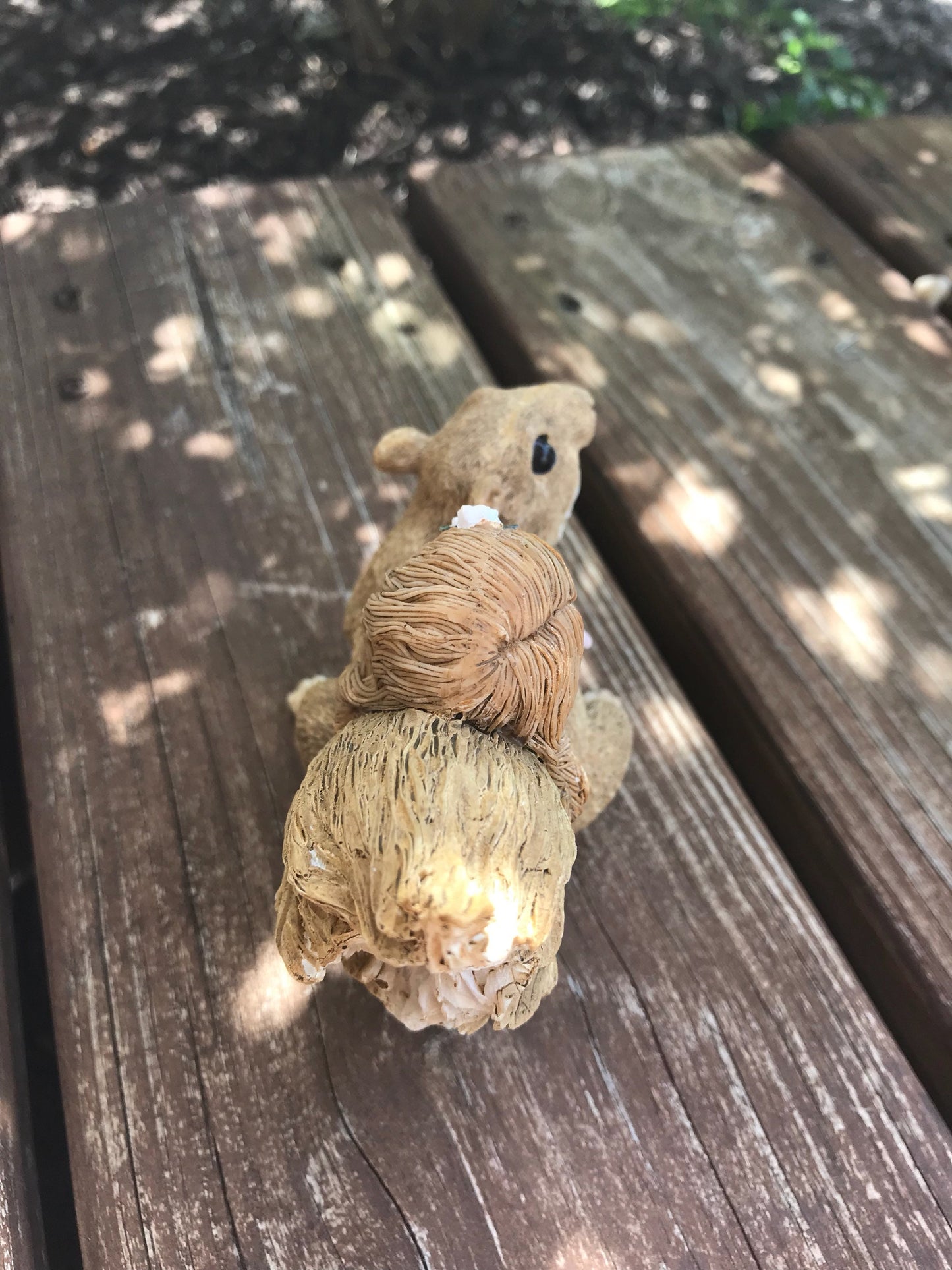 Little sleeping fairy on squirrel, outdoor garden