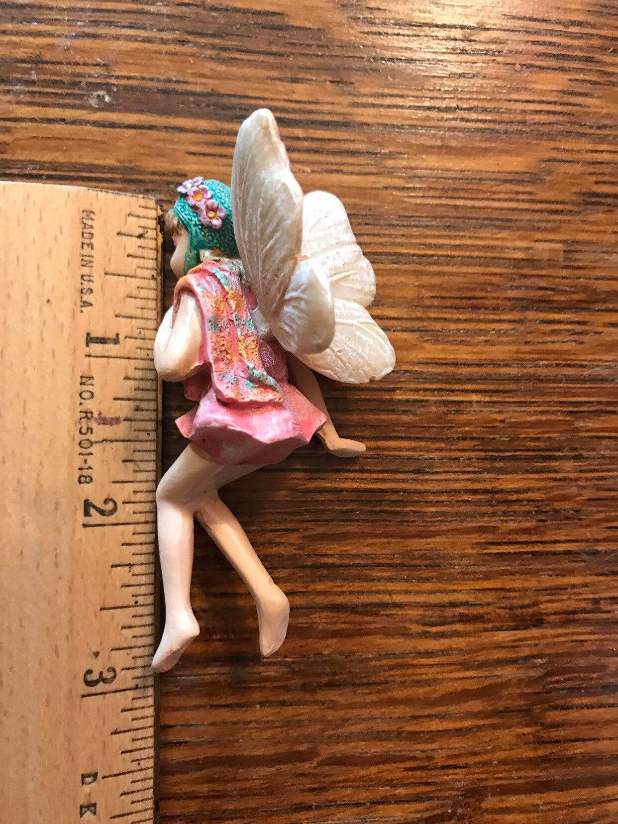 Sweet fairy figurine sitting in swimming suit and ready for summer