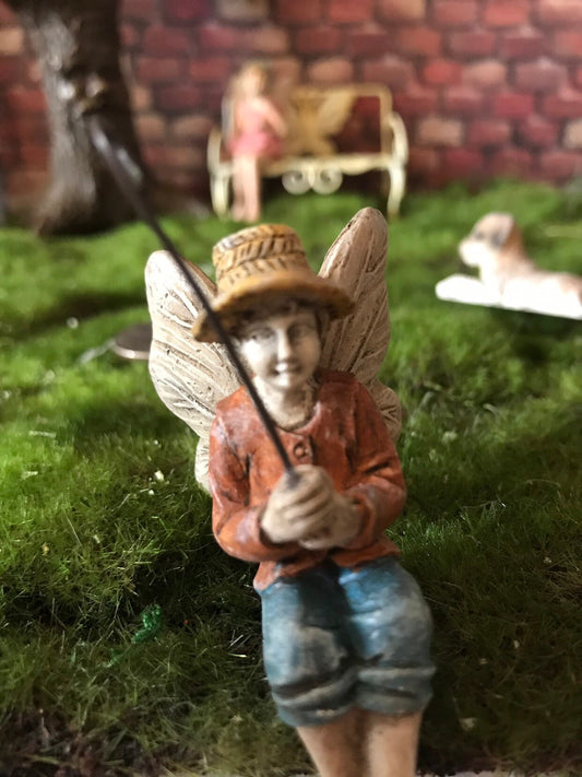 Fairy boy figurine with fishing pole