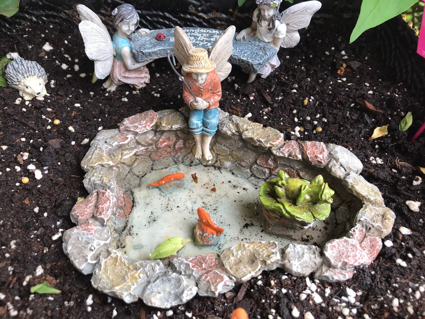 Fairy boy figurine with fishing pole