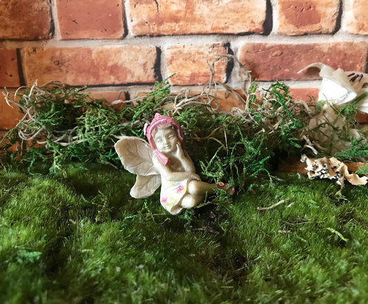 Sweet fairy girl sitting restfully