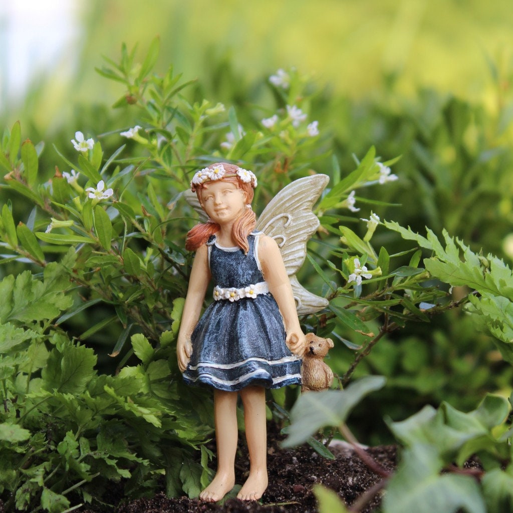 Sweet fairy girl with teddy bear toy