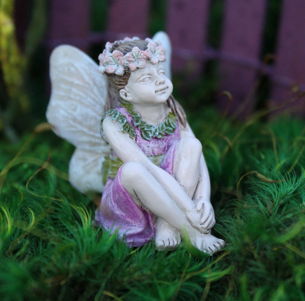 Sweet fairy girl sitting restfully looking so delicate