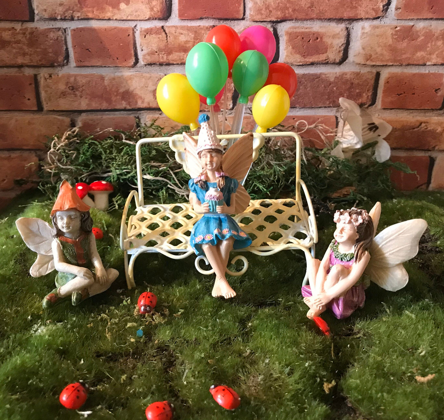 Birthday party girl fairy sitting with her friends holding cupcake