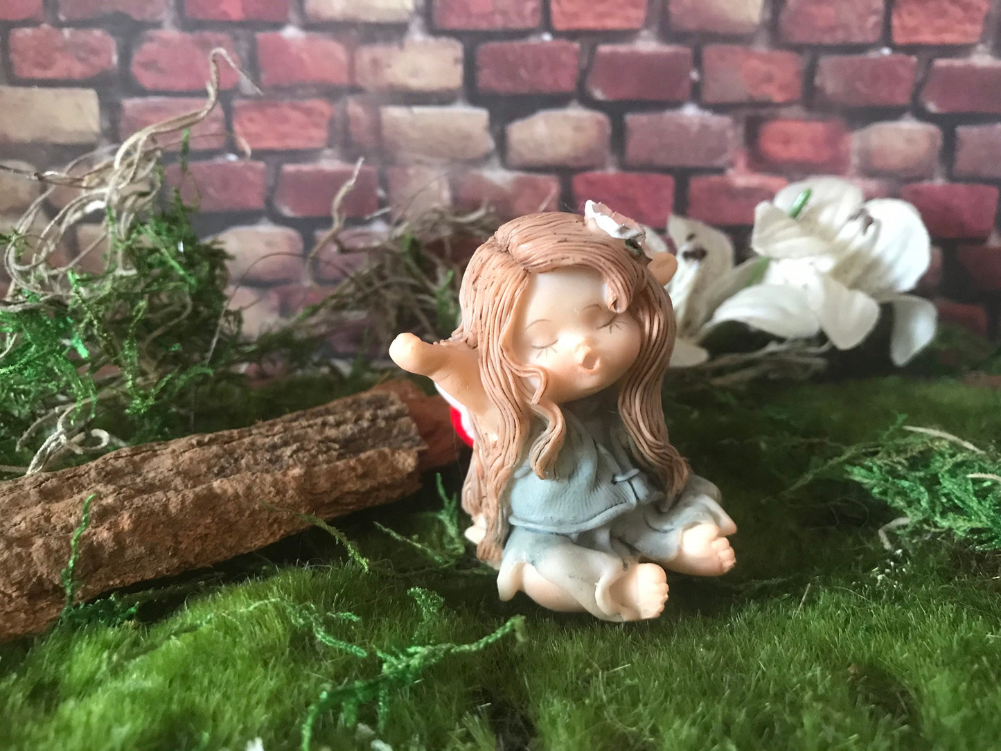 Sweet, yawning, miniature fairy with pretty brown hair fairy