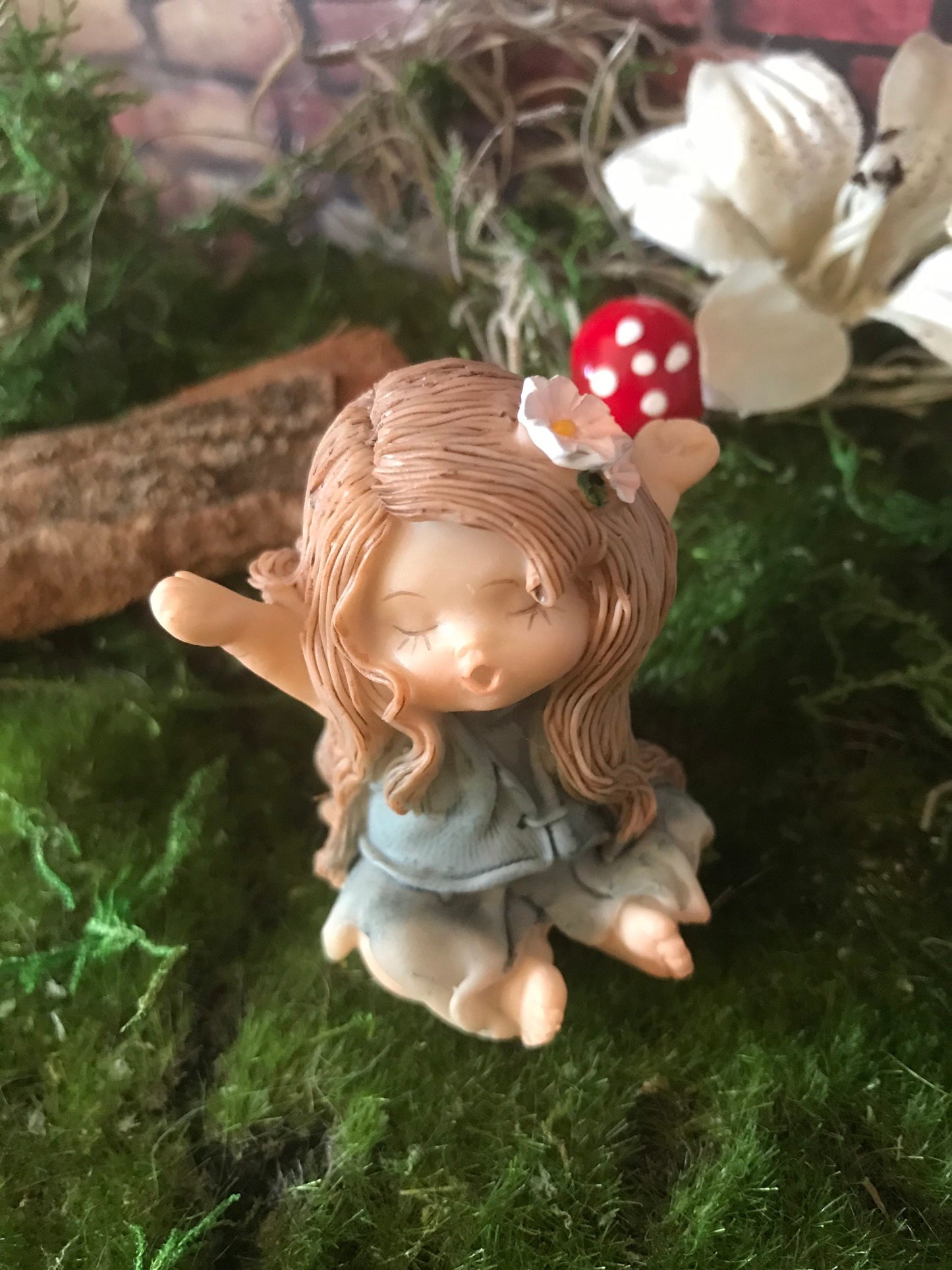 Sweet, yawning, miniature fairy with pretty brown hair fairy
