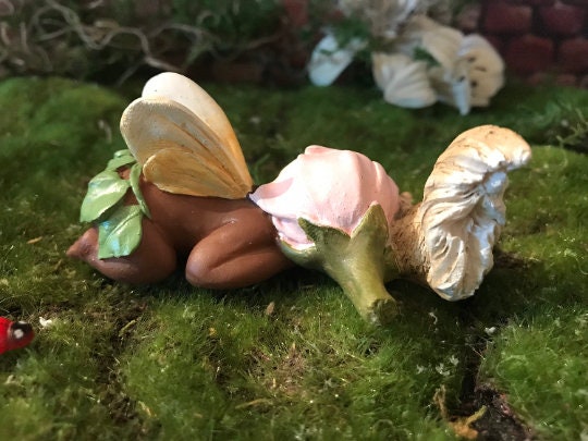 Precious baby fairy is sleeping peacefully while resting her sweet head on her precious squirrel friend.