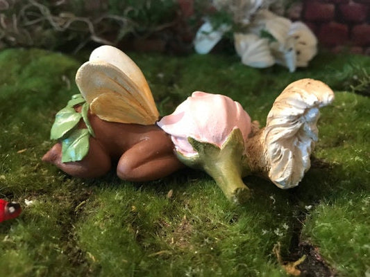 Precious baby fairy is sleeping peacefully while resting her sweet head on her precious squirrel friend.