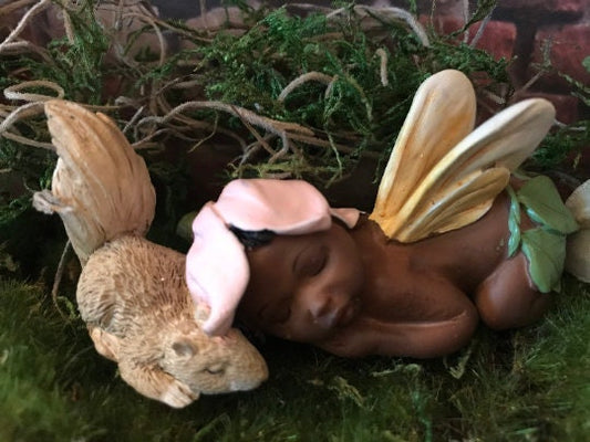 Precious baby fairy is sleeping peacefully while resting her sweet head on her precious squirrel friend.