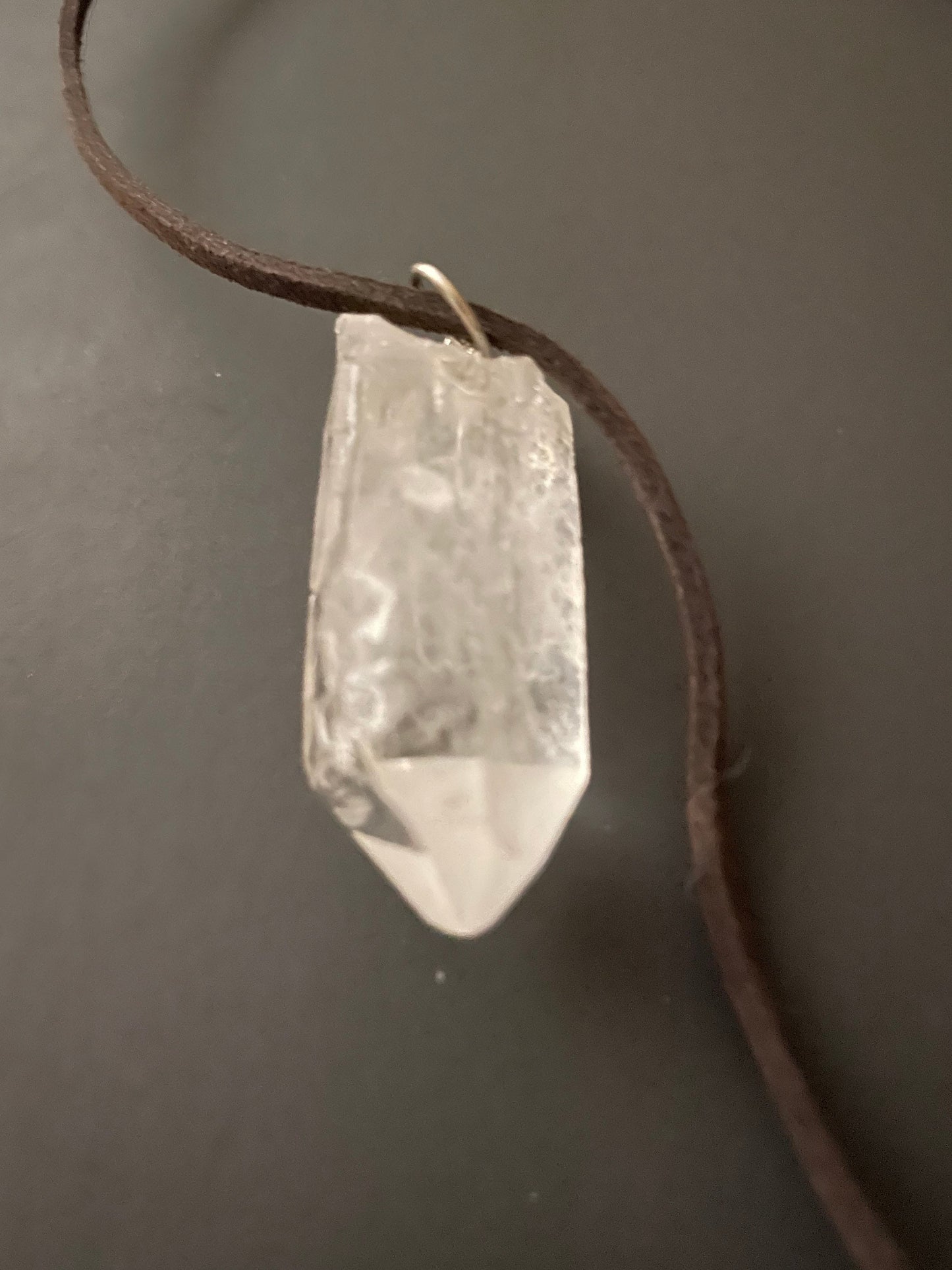 Clear quartz point on 18” brown Swede cord