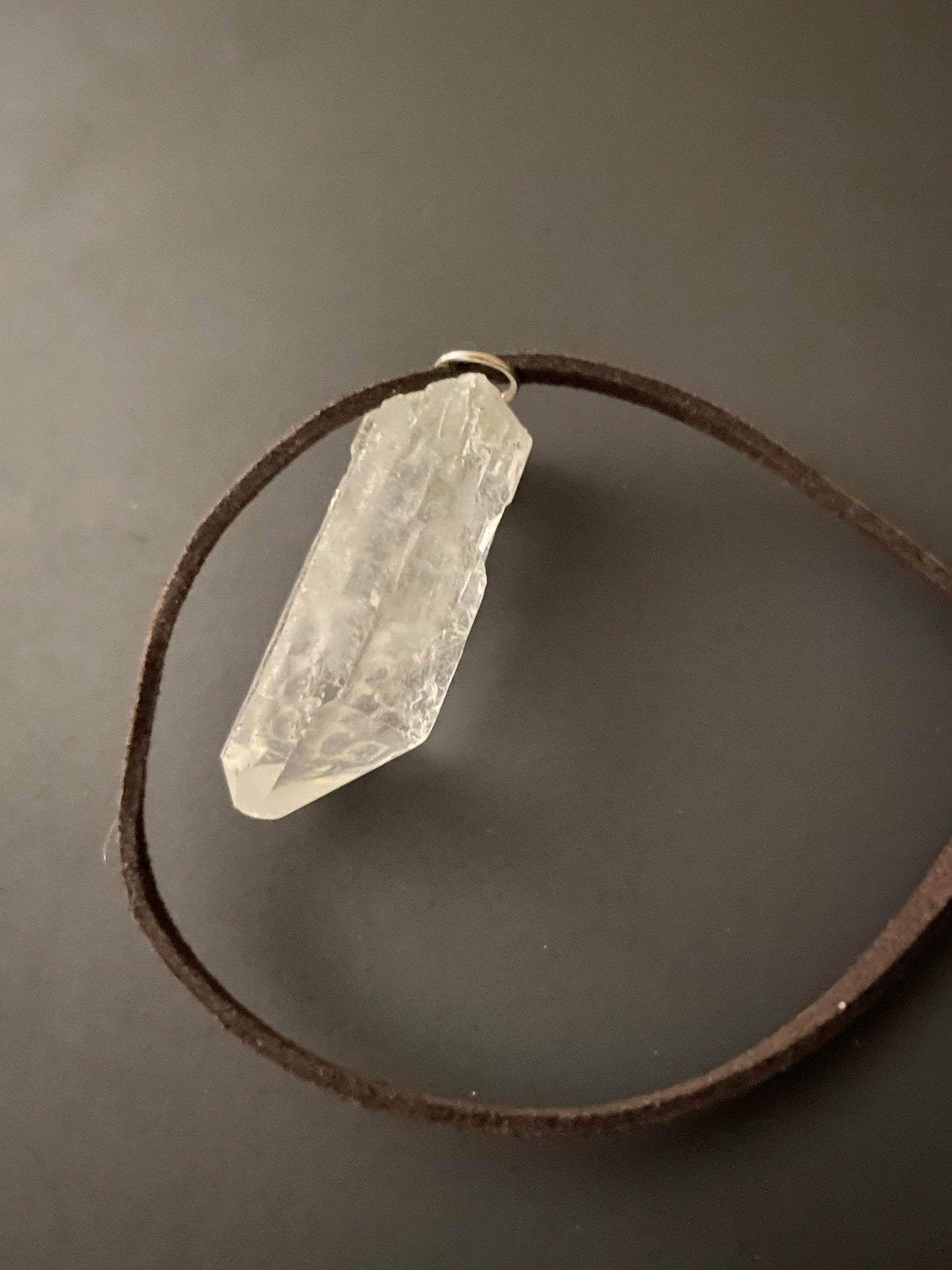 Clear quartz point on 18” brown Swede cord
