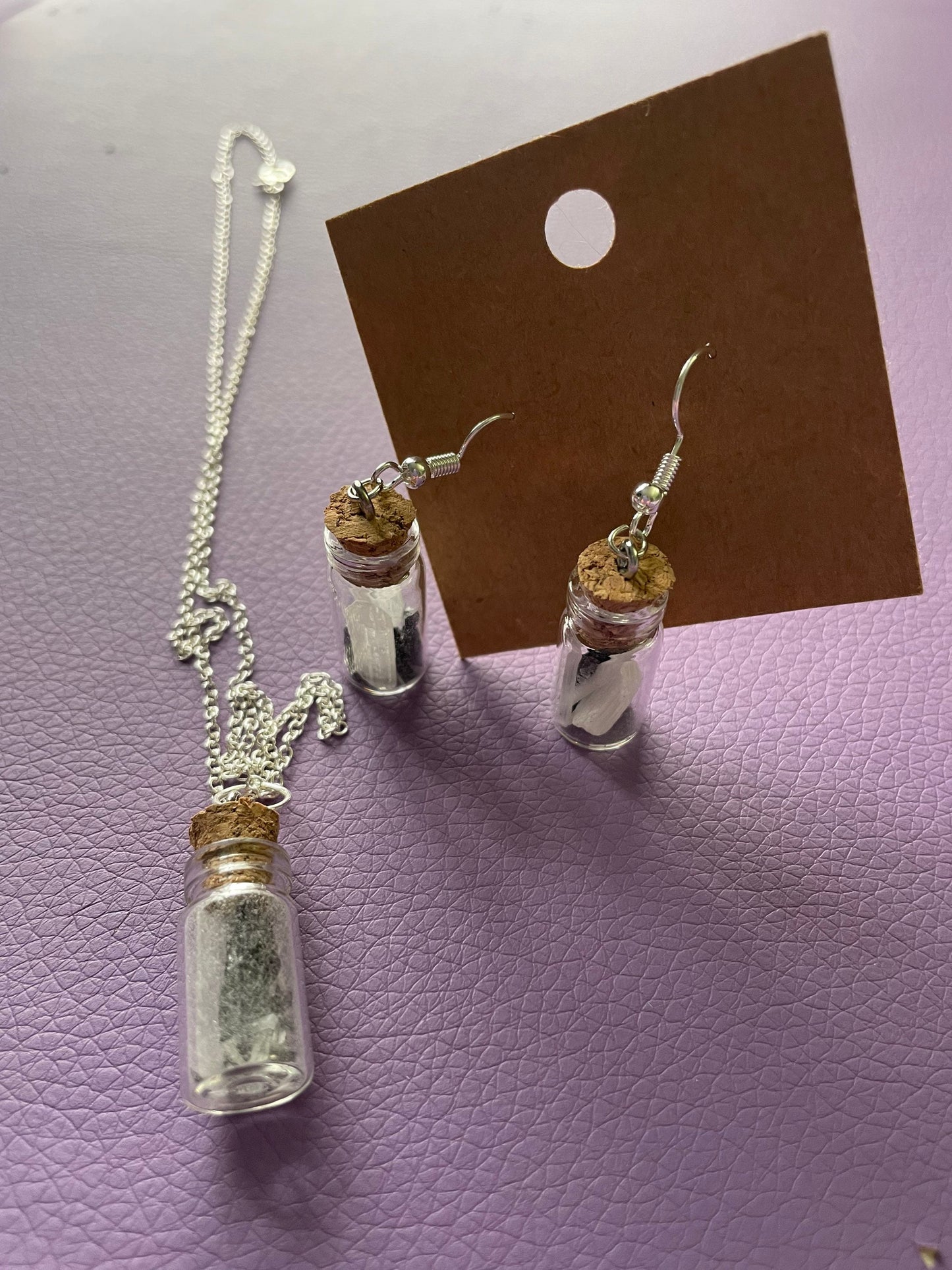 Small bottle earrings and/or necklace filled with a Powerful crystal protection.