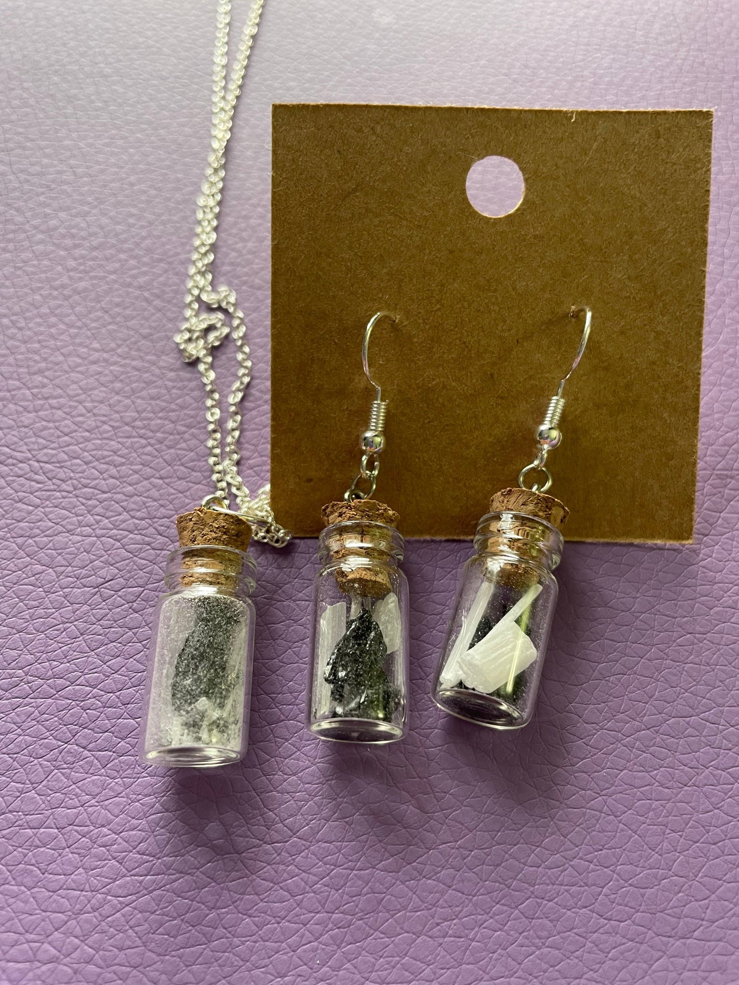 Small bottle earrings and/or necklace filled with a Powerful crystal protection.