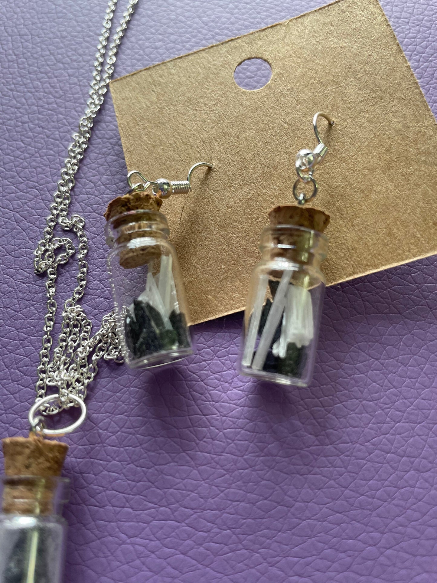 Small bottle earrings and/or necklace filled with a Powerful crystal protection.