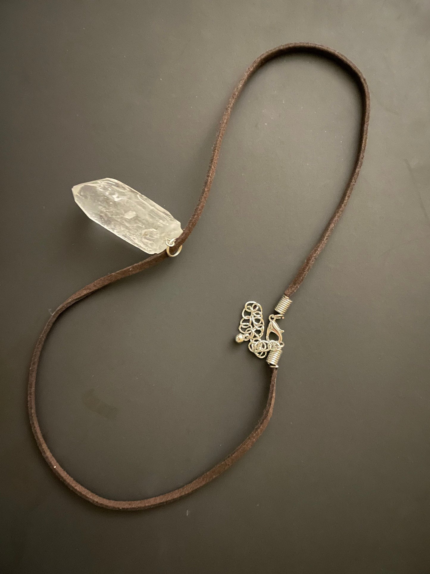 Clear quartz point on 18” brown Swede cord