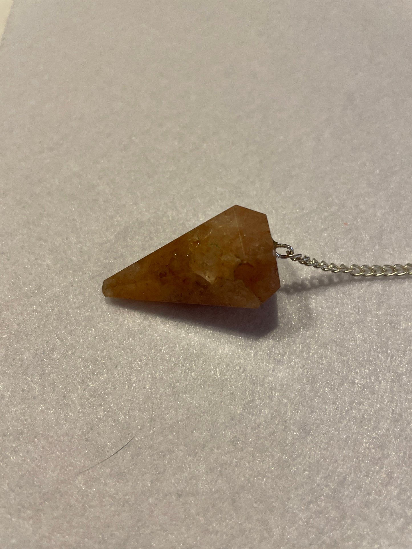 Beautiful Carnelian Pendulum is 1.25” and with the chain it is approximately 9.5”