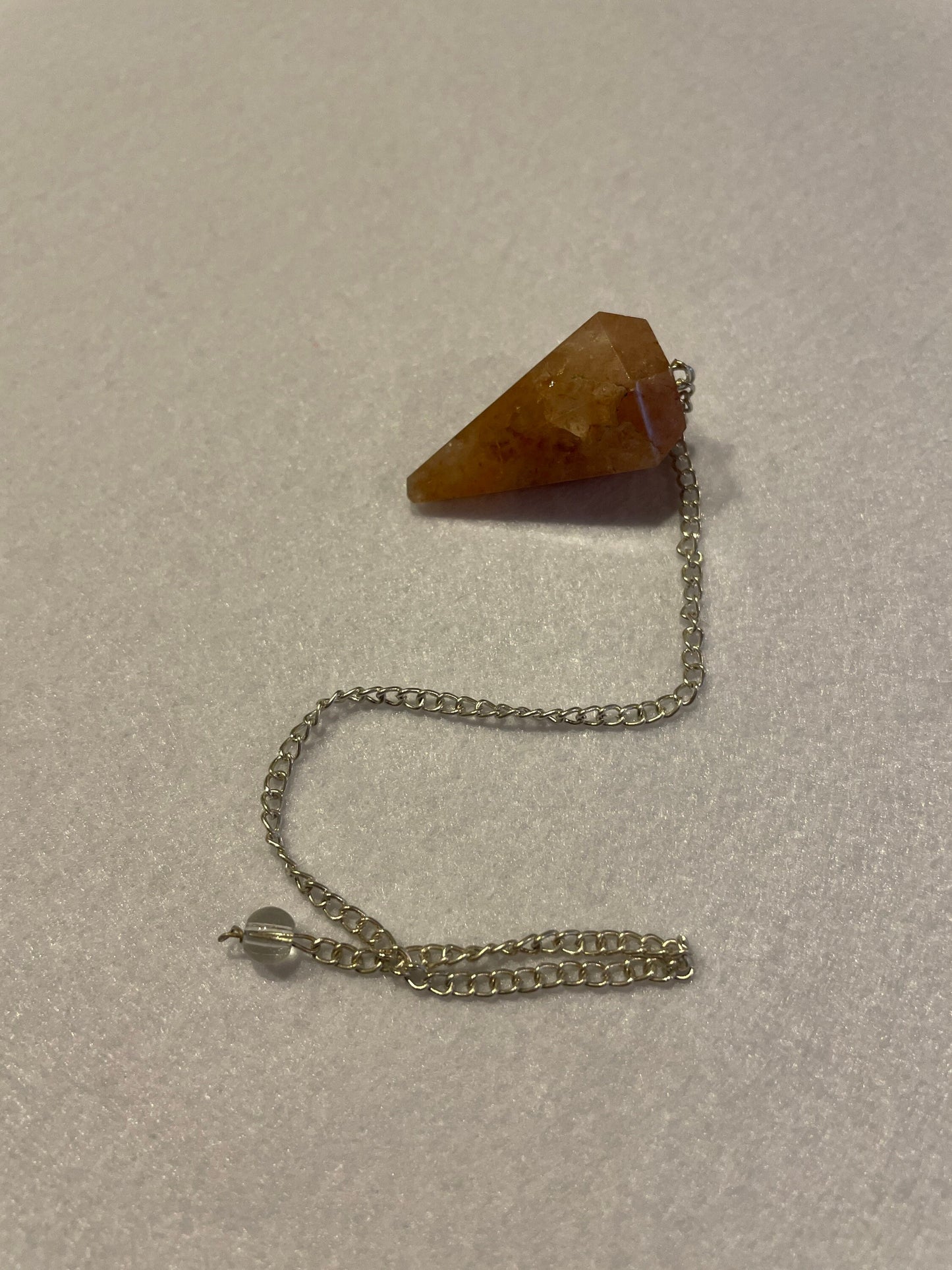 Beautiful Carnelian Pendulum is 1.25” and with the chain it is approximately 9.5”