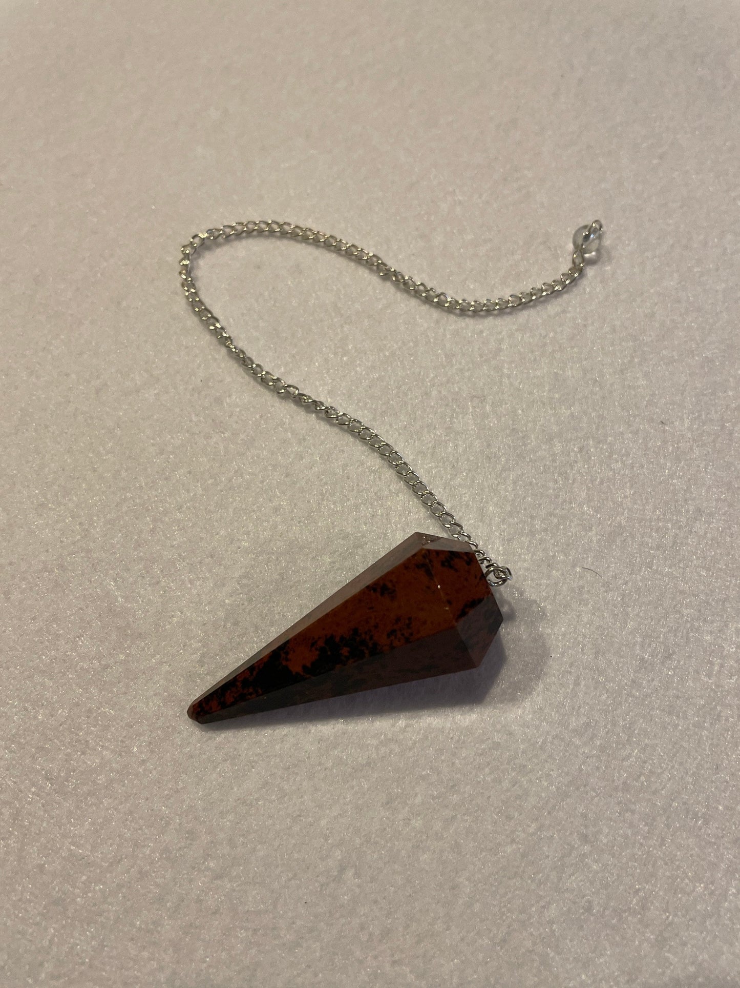 Beautiful Mahogany Obsidian Pendulum 2” stone with chain 9”.