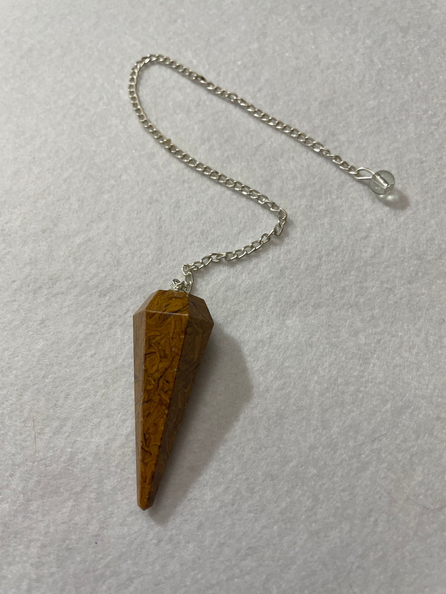 This beautiful Yellow Jasper Pendulum is 1.75” with the chain it is approximately 10.5”.