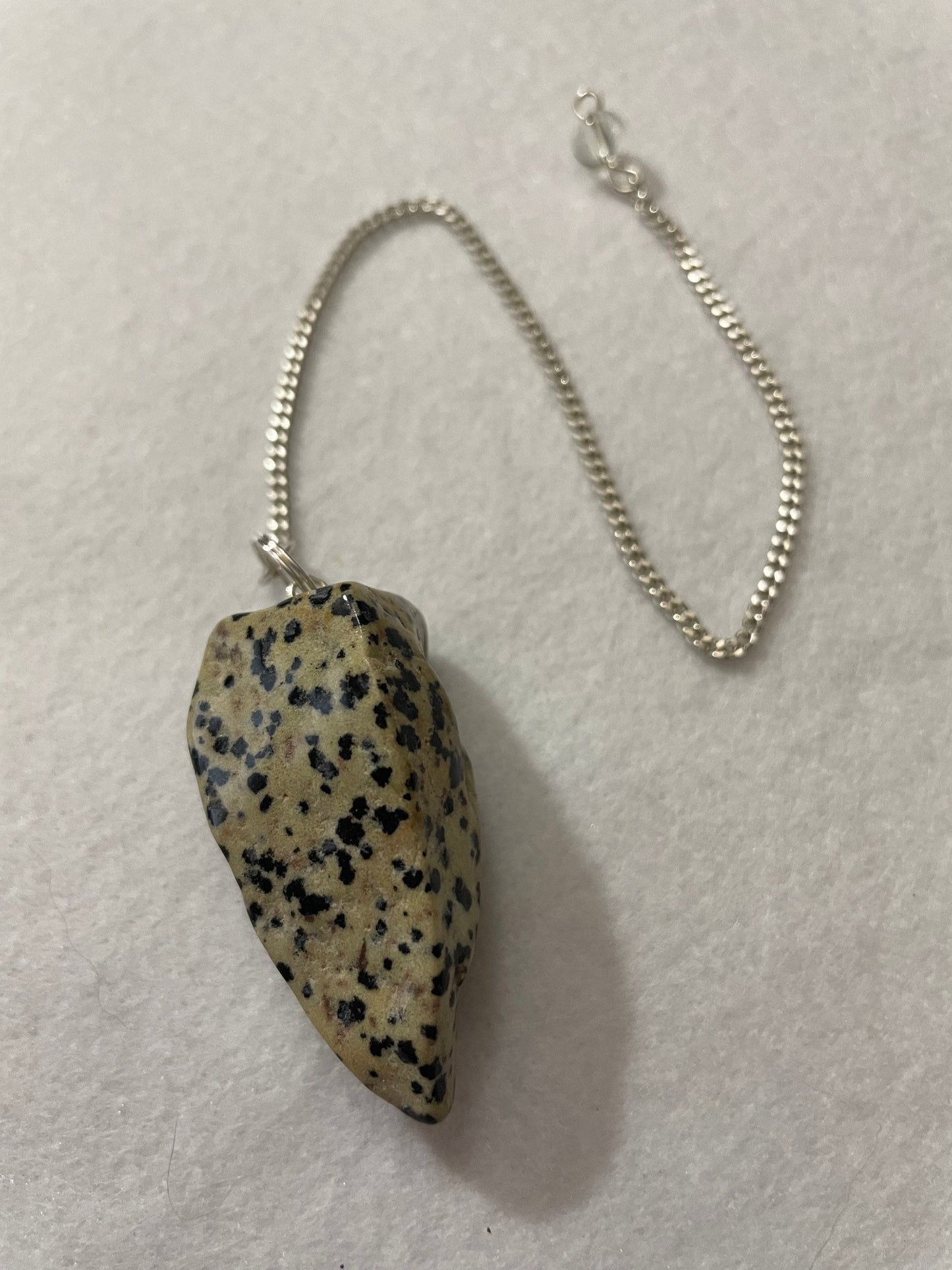 This Dalmatian Jasper Pendulum is 1.75” and with the chain is 9.5”
