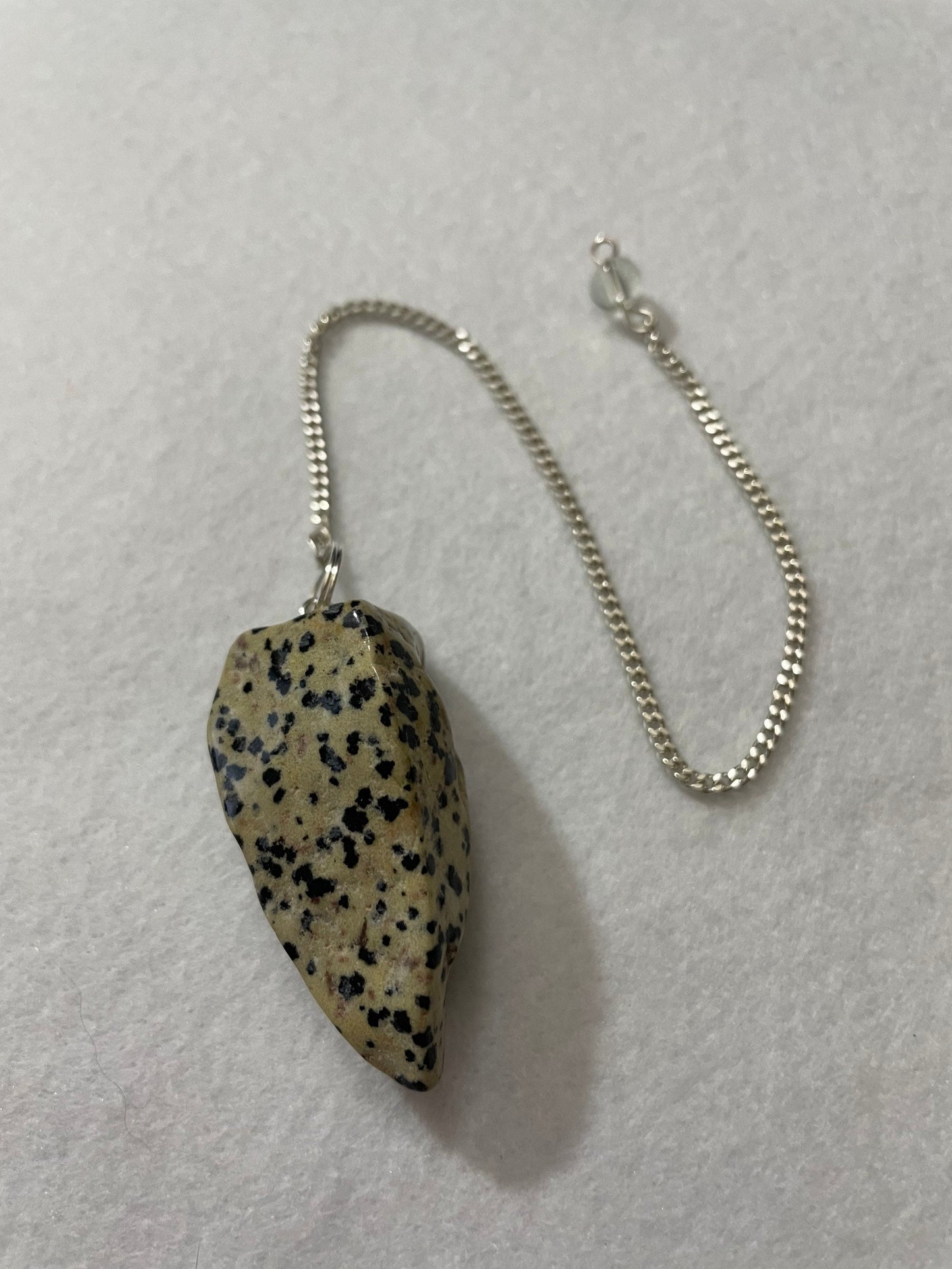 This Dalmatian Jasper Pendulum is 1.75” and with the chain is 9.5”