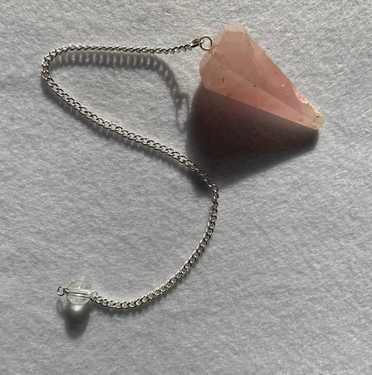 This beautiful Rose Quartz Pendulum is 1.65” and with chain is 8.5”.