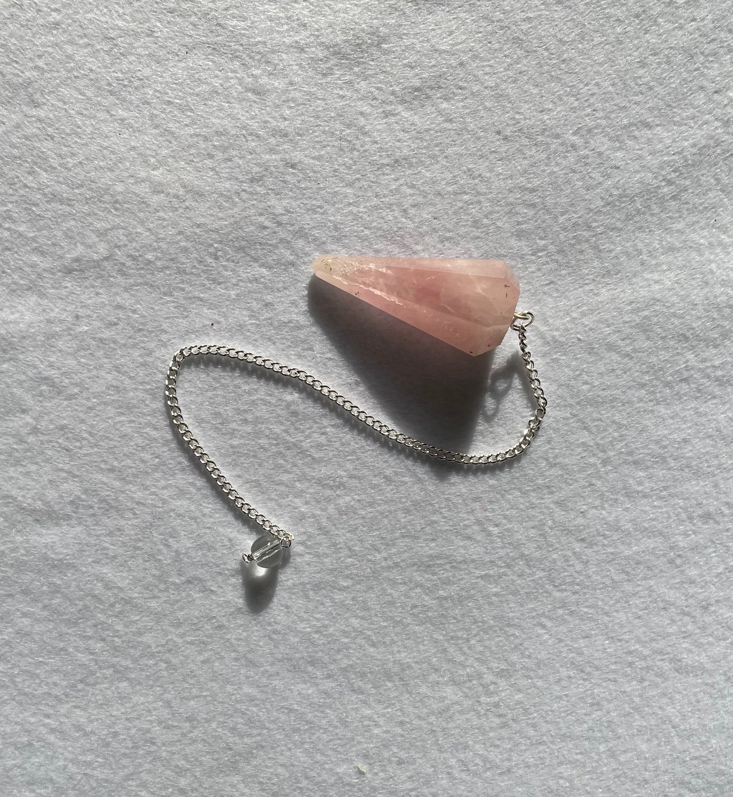 This beautiful Rose Quartz Pendulum is 1.65” and with chain is 8.5”.