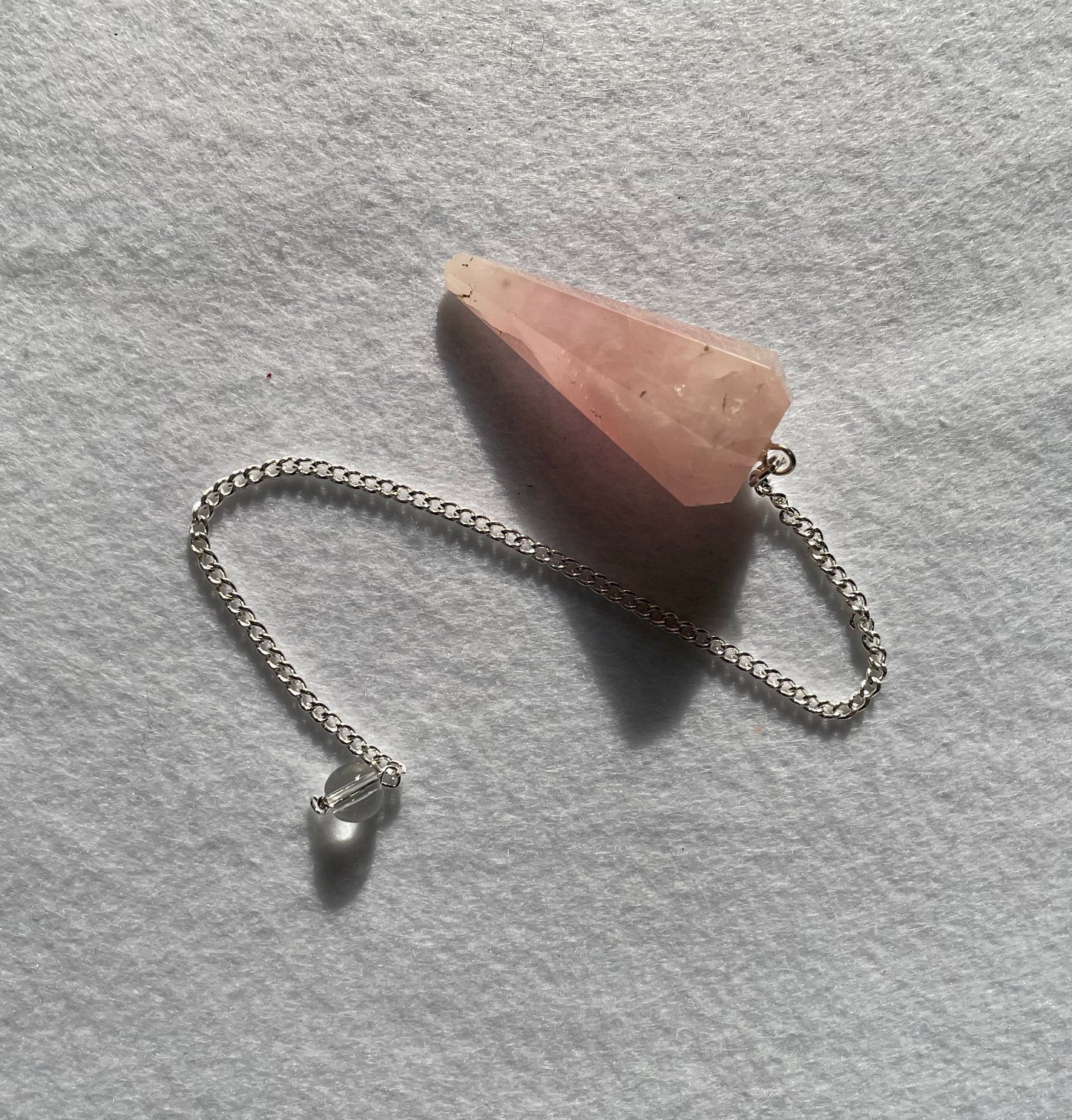 This beautiful Rose Quartz Pendulum is 1.65” and with chain is 8.5”.