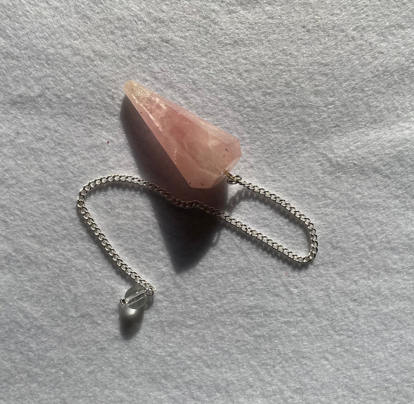 This beautiful Rose Quartz Pendulum is 1.65” and with chain is 8.5”.