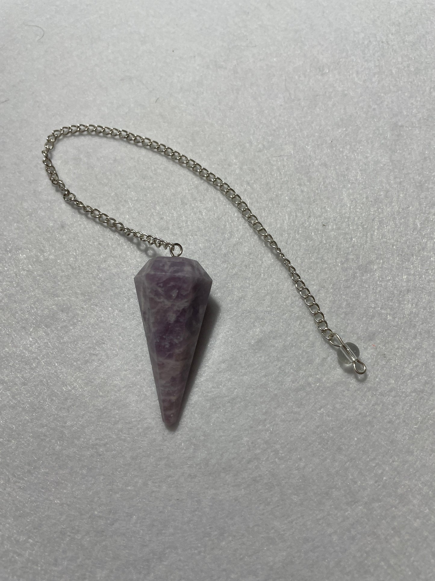 This beautiful Lepidolite Pendulum is 1.65” and with chain is 9”