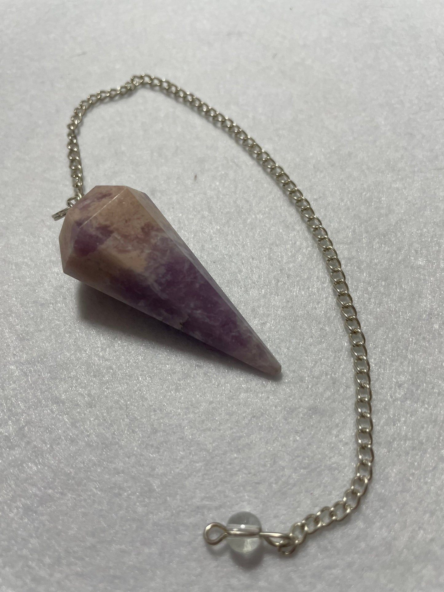This magnificent pink and purple Lepidolite Pendulum is 1.75” and with chain is 9”.