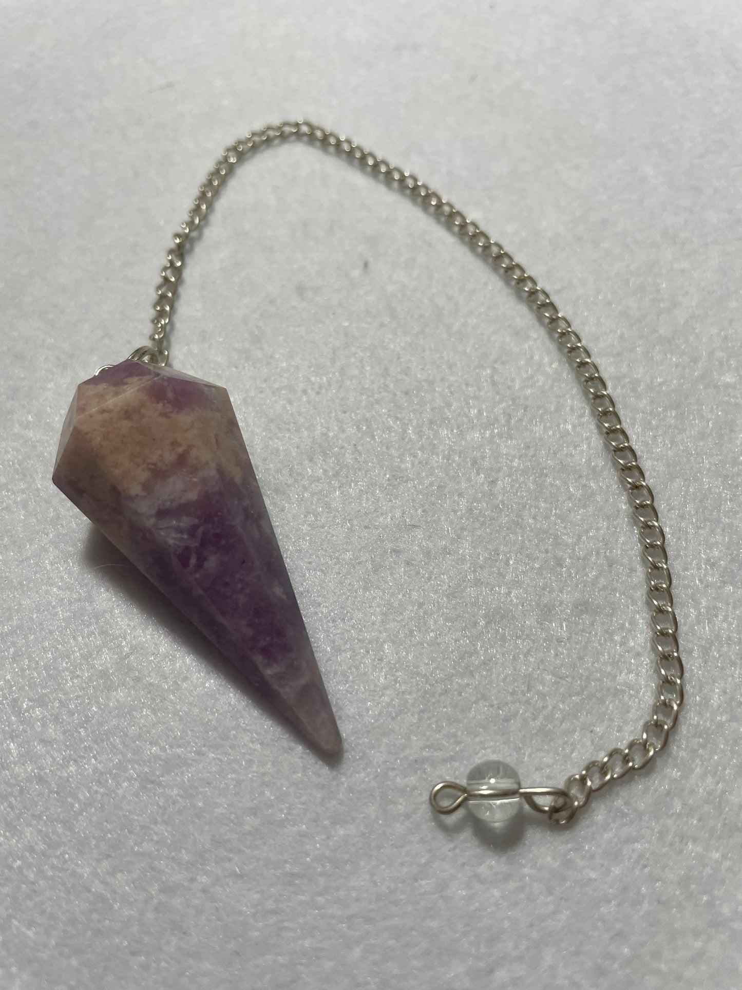 This magnificent pink and purple Lepidolite Pendulum is 1.75” and with chain is 9”.