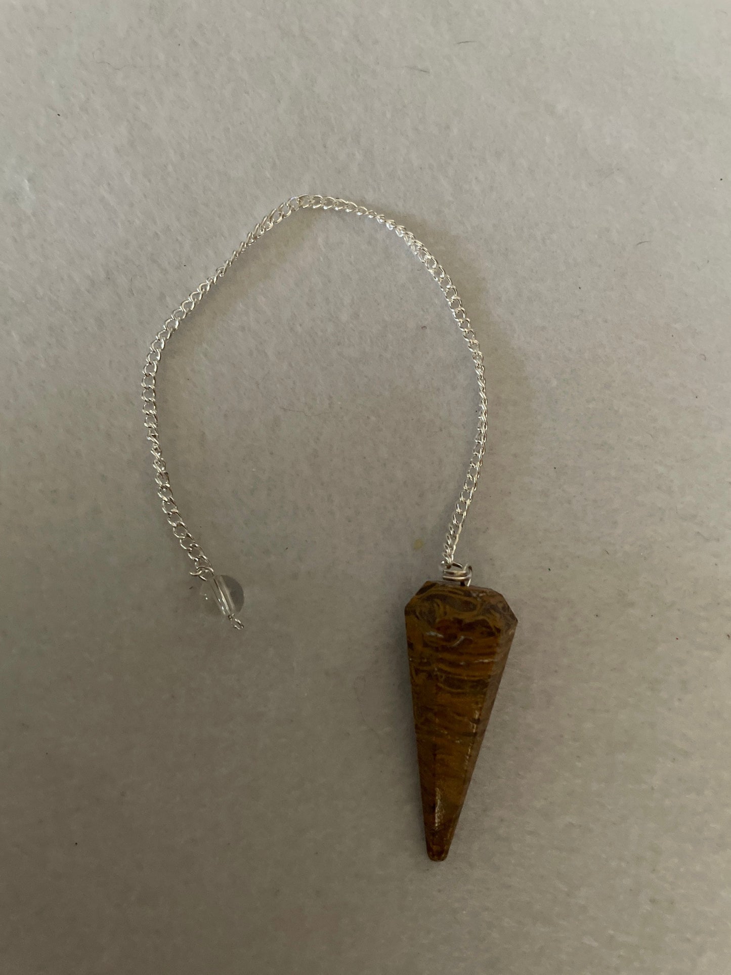 beautiful Yellow Jasper Pendulum is 1.50” and with the chain it is approximately 8”