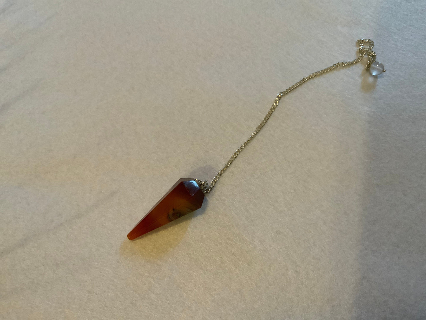 This beautiful Carnelian Pendulum is  1.25” with chain 9”