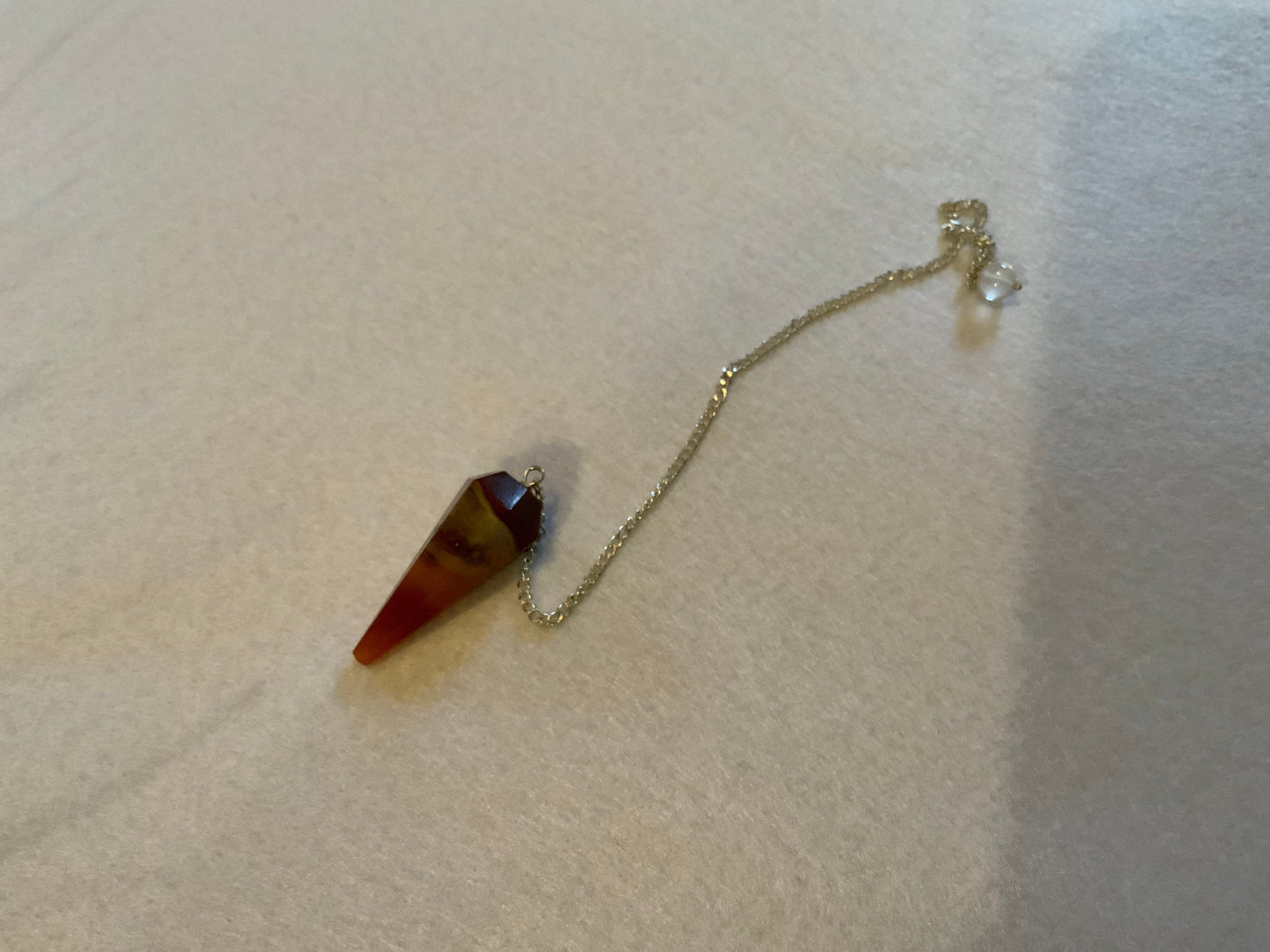 This beautiful Carnelian Pendulum is  1.25” with chain 9”