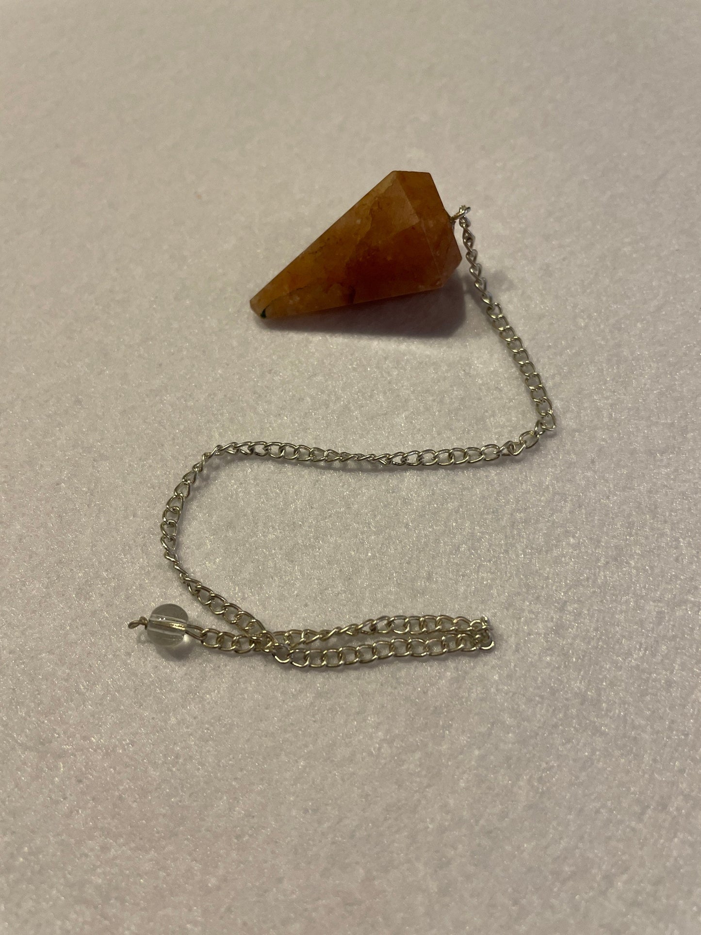 Beautiful Carnelian Pendulum is 1.25” and with the chain it is approximately 9.5”