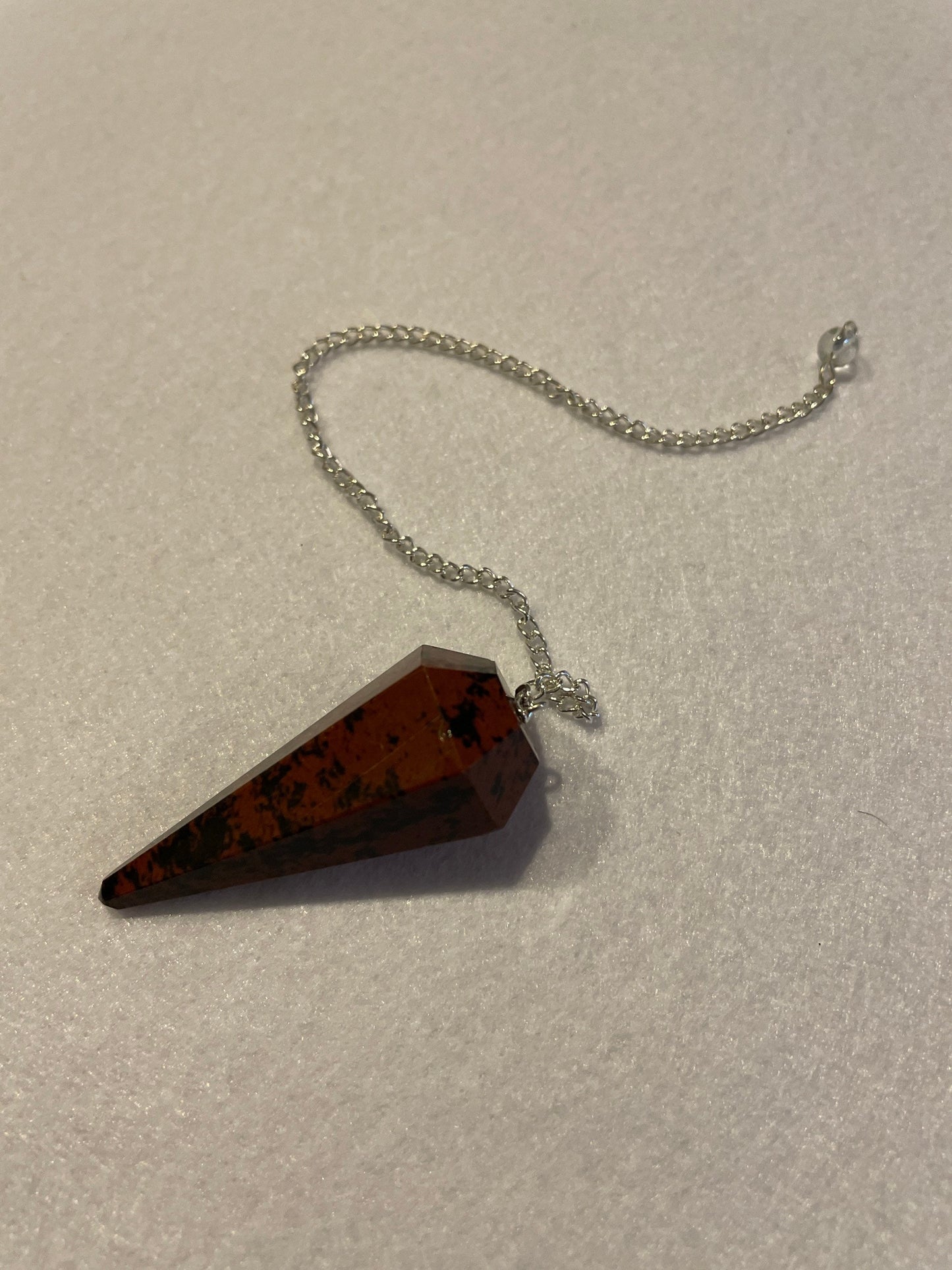 Beautiful Mahogany Obsidian Pendulum 2” stone with chain 9”.