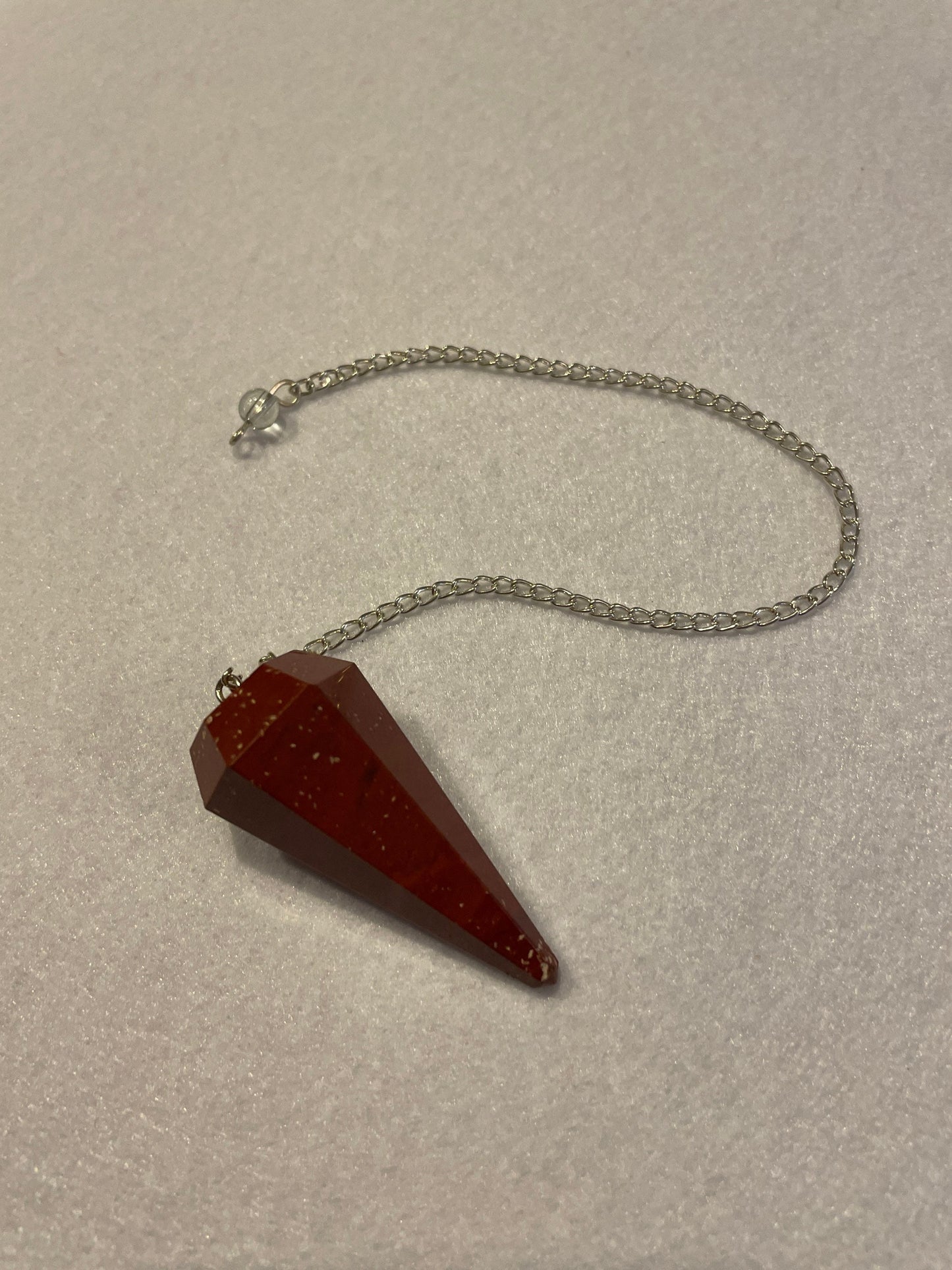 Beautiful Red Jasper Pendulum is 1.75” with chain 9.25”.
