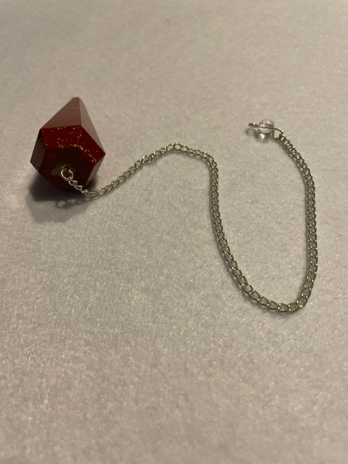 Beautiful Red Jasper Pendulum is 1.75” with chain 9.25”.