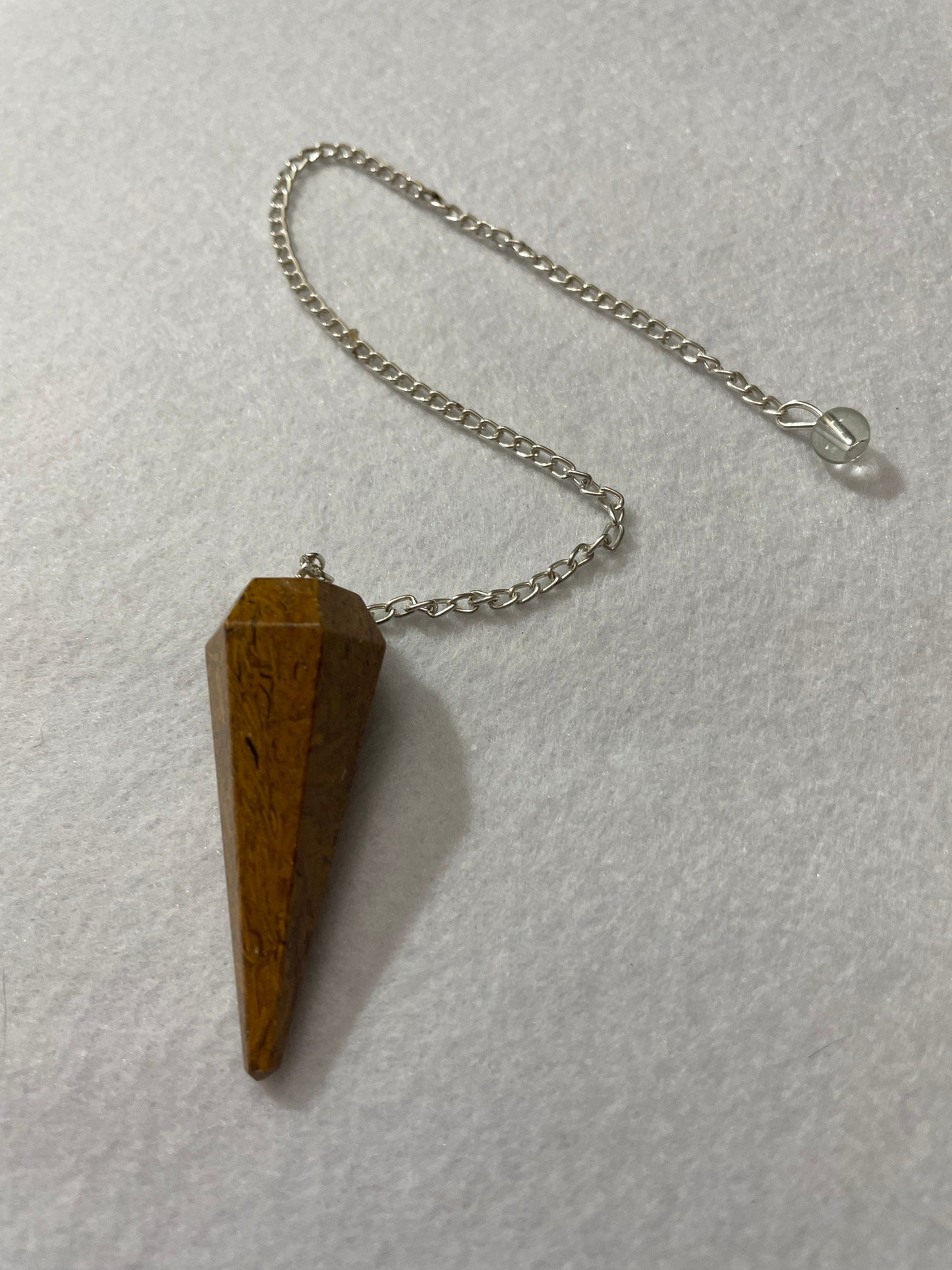 This beautiful Yellow Jasper Pendulum is 1.75” with the chain it is approximately 10.5”.