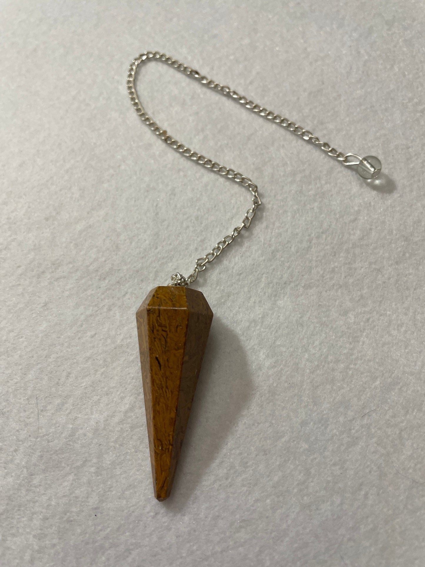 This beautiful Yellow Jasper Pendulum is 1.75” with the chain it is approximately 10.5”.
