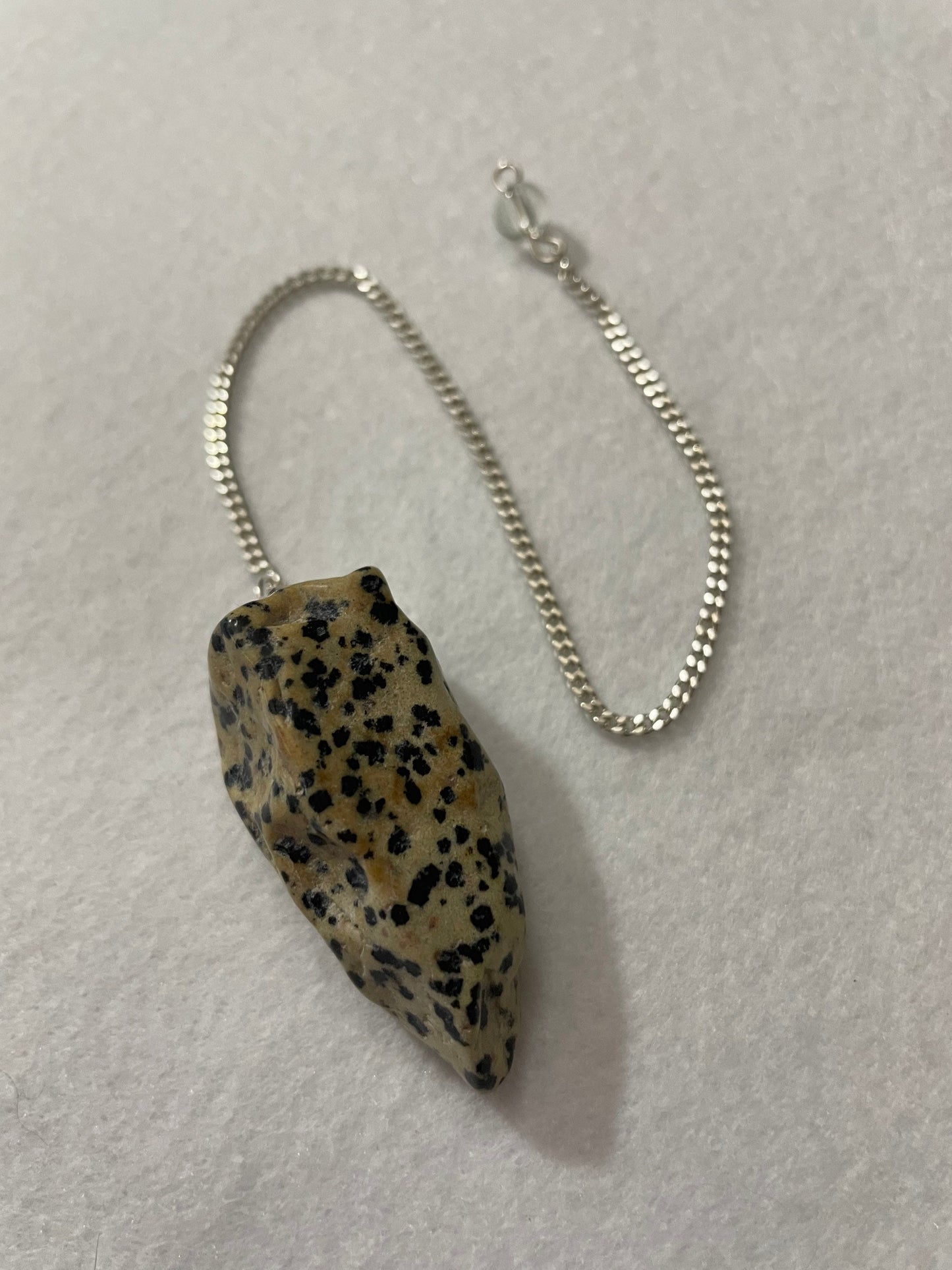 This Dalmatian Jasper Pendulum is 1.75” and with the chain is 9.5”